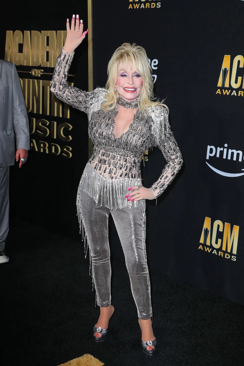 One of the night's host, Dolly Parton, walked the red carpet in a sparkly suit with fringe.